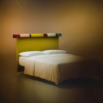 Bolzan Letti's Rosary bed with fabric headboard and glossy lacquered finish.