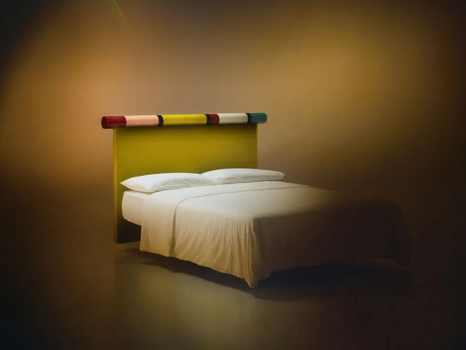 Bolzan Letti's Rosary bed with fabric headboard and glossy lacquered finish.