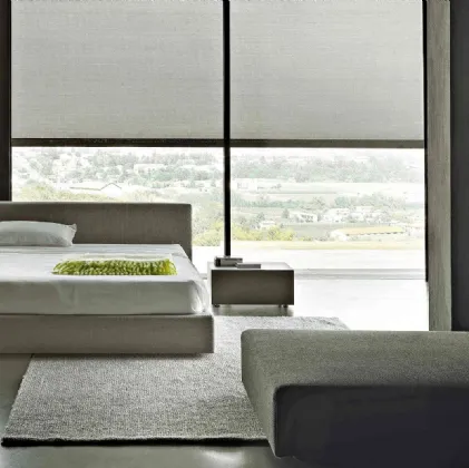 Bed with linear design in fully removable fabric with Softland headboard by Lema.