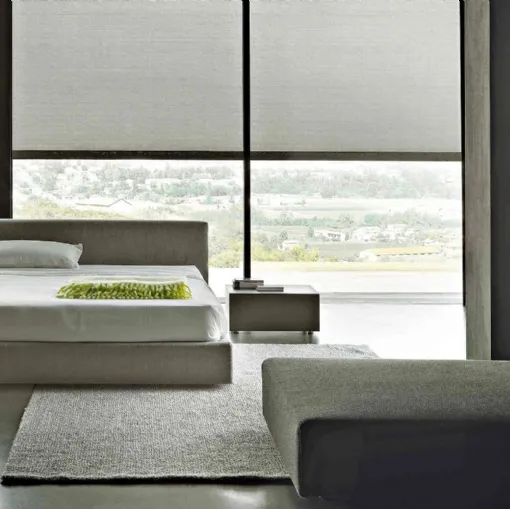 Bed with linear design in fully removable fabric with Softland headboard by Lema.