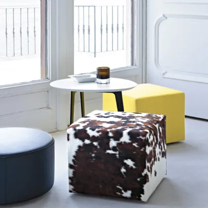 Square and round poufs in leather or fabric by Lema.